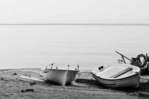 Two empty boats on the beach.