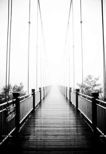 view on pedestrian wooden bridge in mist