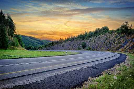 Landscape with curvy road at sunset