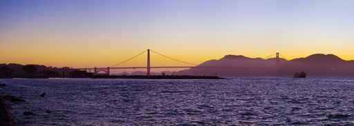 The Golden Gate Bridge silhouetted at sunset
