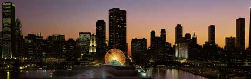 This is Navy Pier and the skyline at sunset during summer. The Ferris wheel on Navy Pier is to the right of center in front of the Lake Point Tower condominium building.