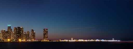 Chicago city skyline and lake Michigan shore navy pier at night
