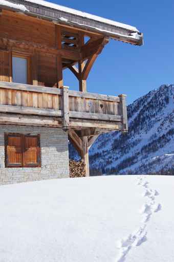 Chalet with prints in the snow