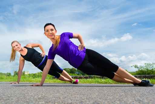 Sports outdoor - young women doing fitness in park