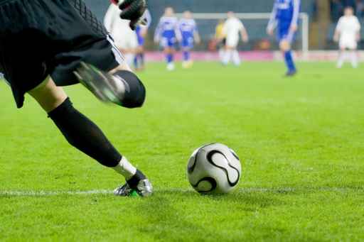 soccer or football goalkeeper kick the ball